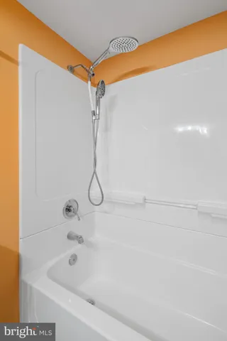 a picture of a room with a white wall and a painting