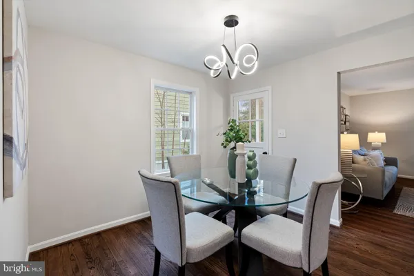 a view of a dining room with furniture wooden floor and chandelier