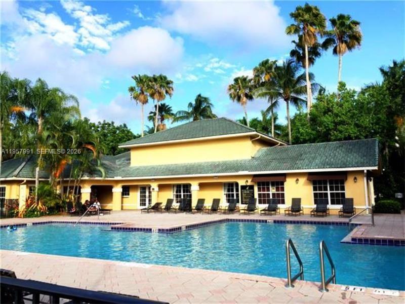 4055 West McNab Road, Unit H311 Pompano Beach, FL 33069 - Photo 9 of 14 a view of house with swimming pool and a yard