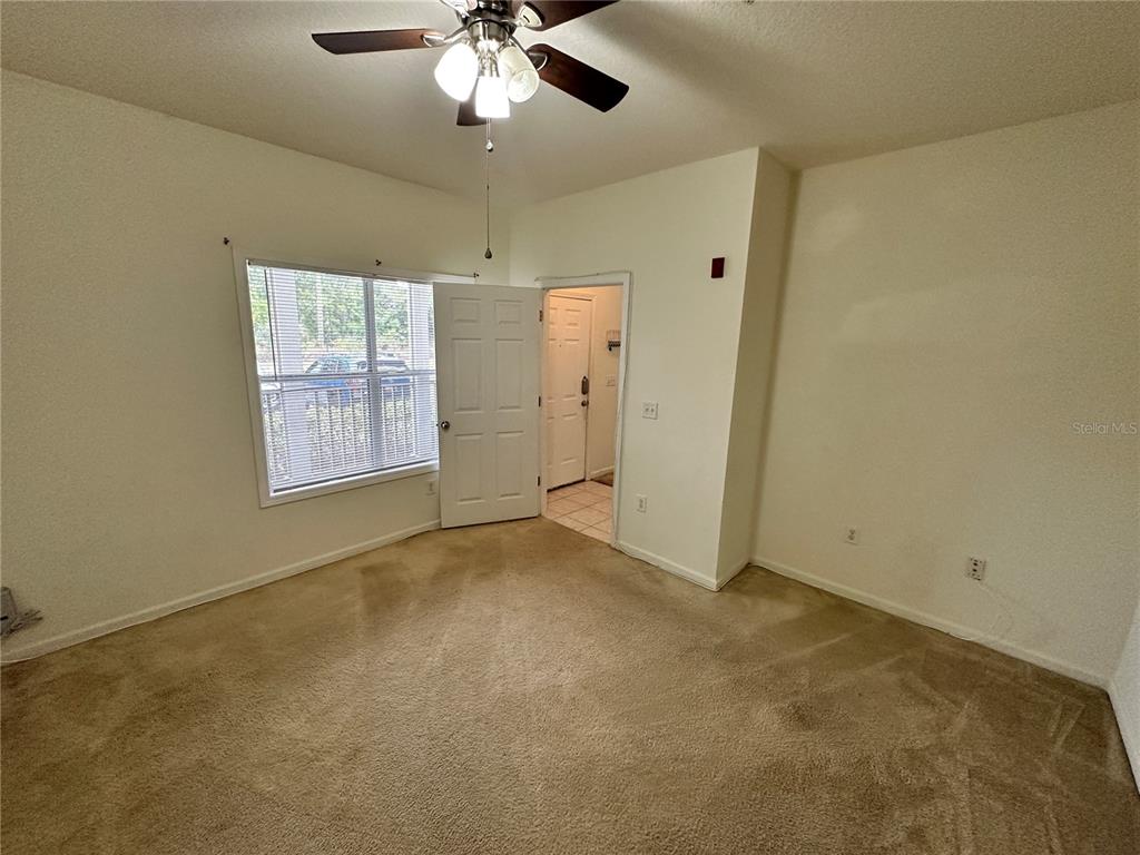 4802 51st Street West, Unit 413 Bradenton, FL 34210 - Photo 12 of 40 en empty room with windows and fan