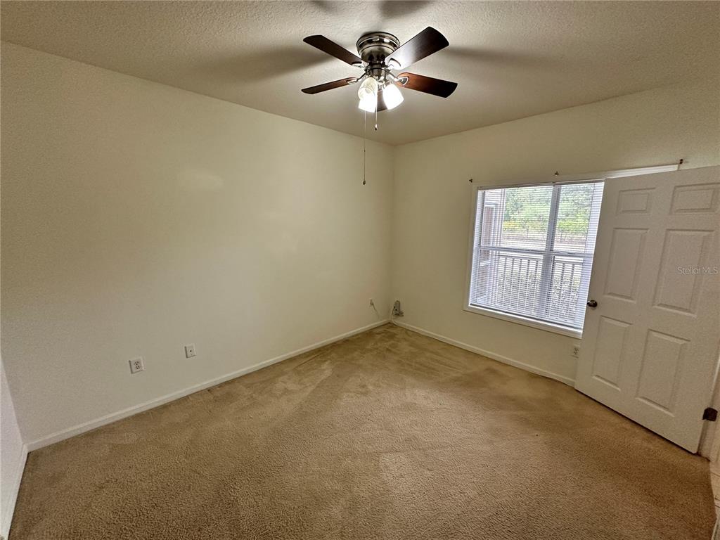 4802 51st Street West, Unit 413 Bradenton, FL 34210 - Photo 13 of 40 an empty room with windows and fan