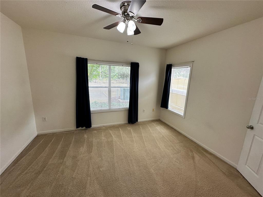 4802 51st Street West, Unit 413 Bradenton, FL 34210 - Photo 17 of 40 a view of an empty room with window chandelier fan