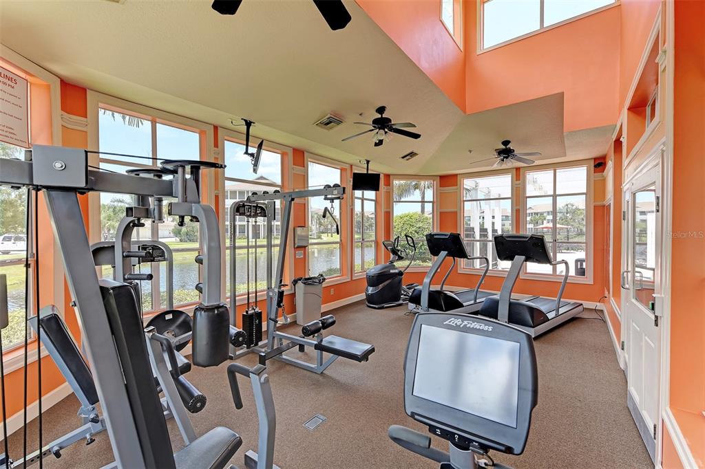 4802 51st Street West, Unit 413 Bradenton, FL 34210 - Photo 28 of 40 a room with gym equipment and a large window