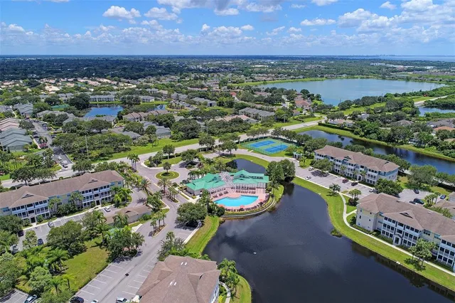 an aerial view of a houses with a lake view