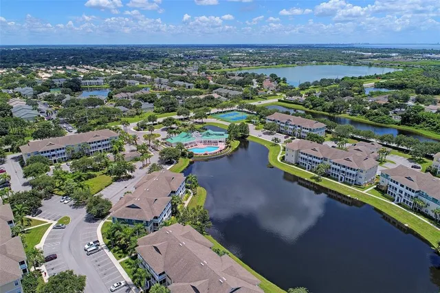 an aerial view of a houses with a lake view