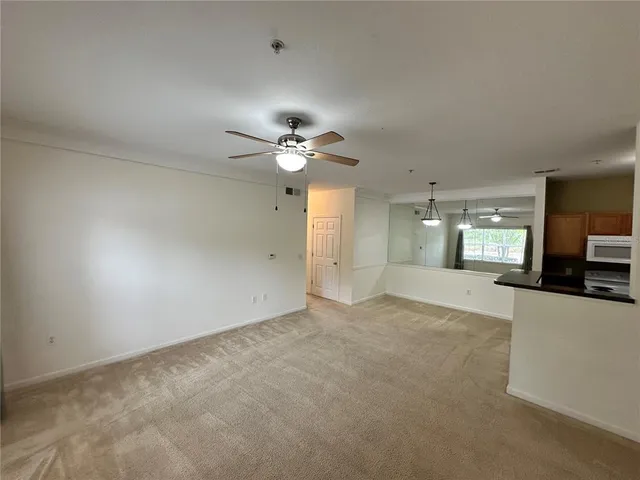 a view of a livingroom with a kitchen