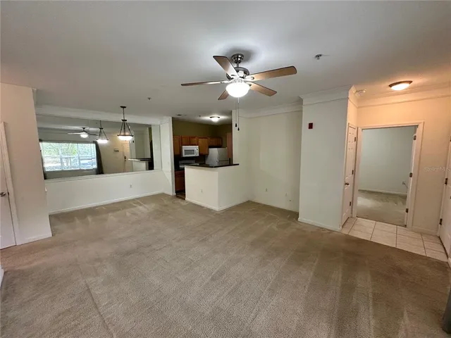 a view of a kitchen with a sink and a chandelier fan