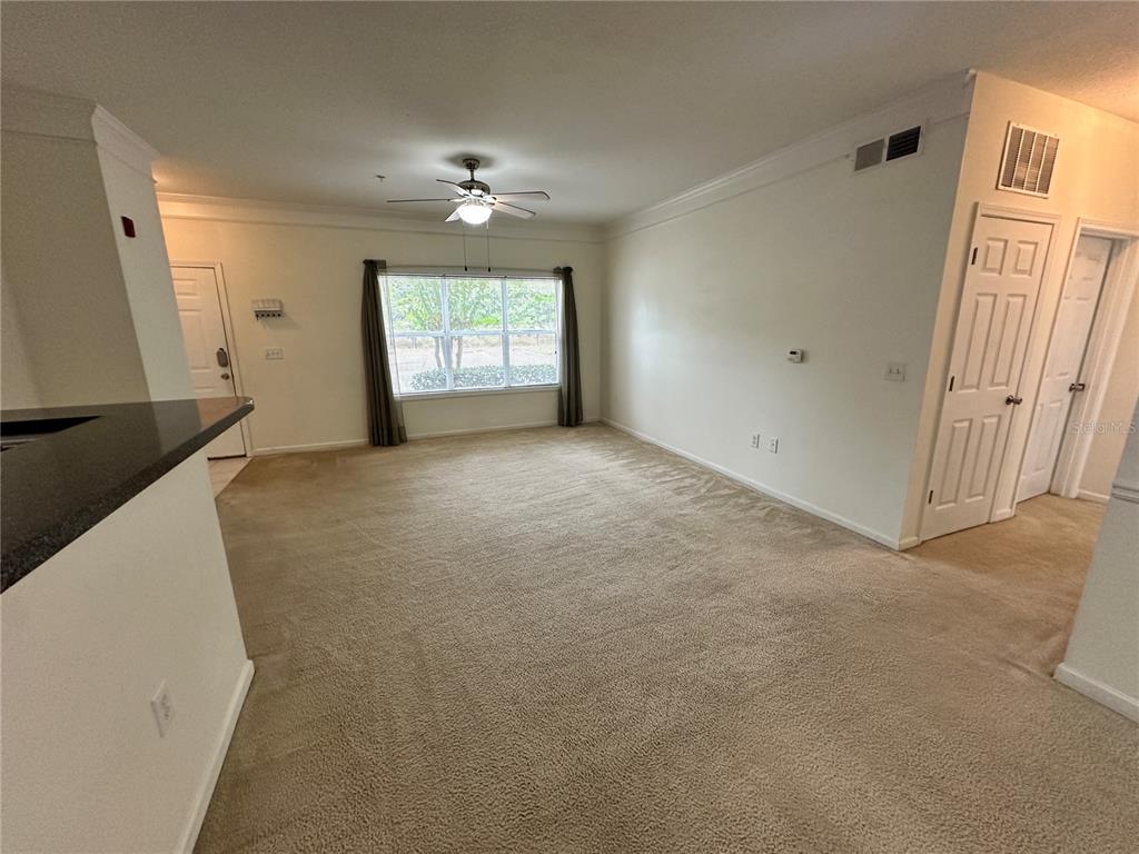 4802 51st Street West, Unit 413 Bradenton, FL 34210 - Photo 6 of 40 an empty room with windows and entrance