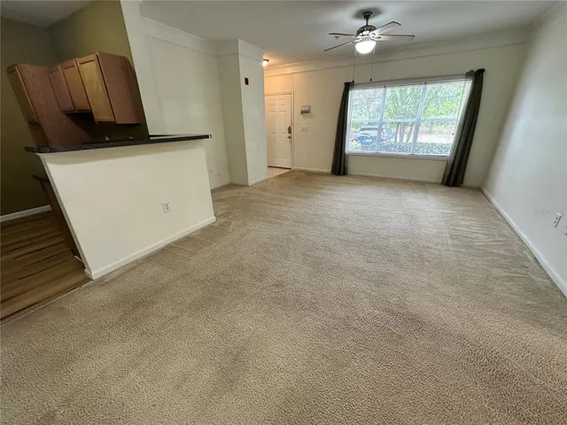 an empty room with windows and cabinet