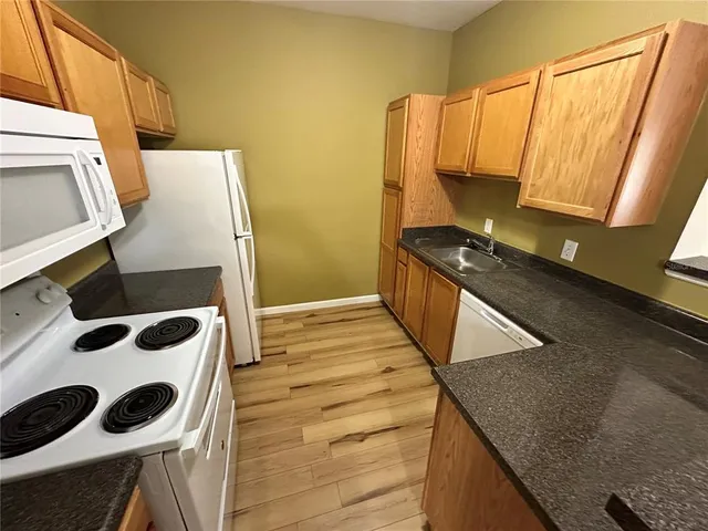 a kitchen with a sink and a stove top oven