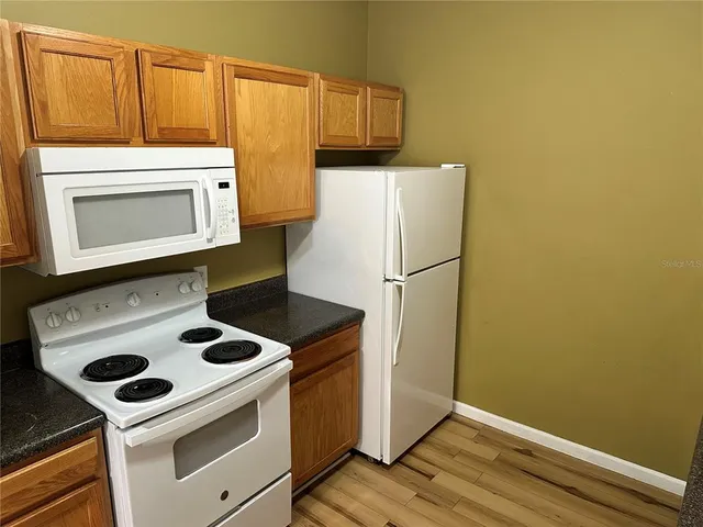 a kitchen with a stove and a microwave