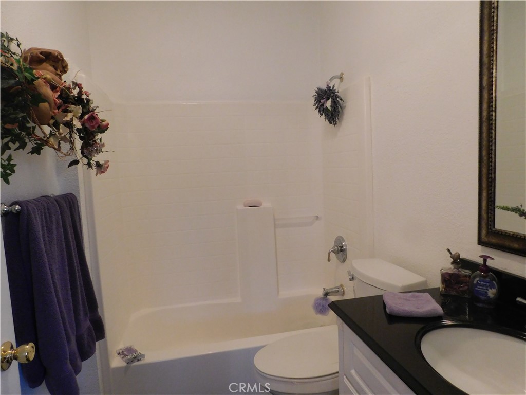 8934 Japatul Road Apple Valley, CA 92308 - Photo 11 of 16 a bathroom with a granite countertop sink toilet and shower