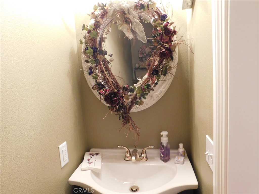 8934 Japatul Road Apple Valley, CA 92308 - Photo 16 of 16 a bathroom with a sink and a mirror