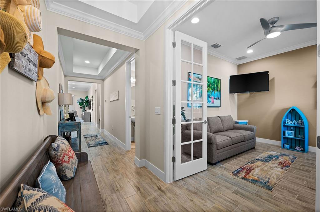 3521 Pilot Circle Naples, FL 34120 - Photo 12 of 36 a living room with furniture and a flat screen tv