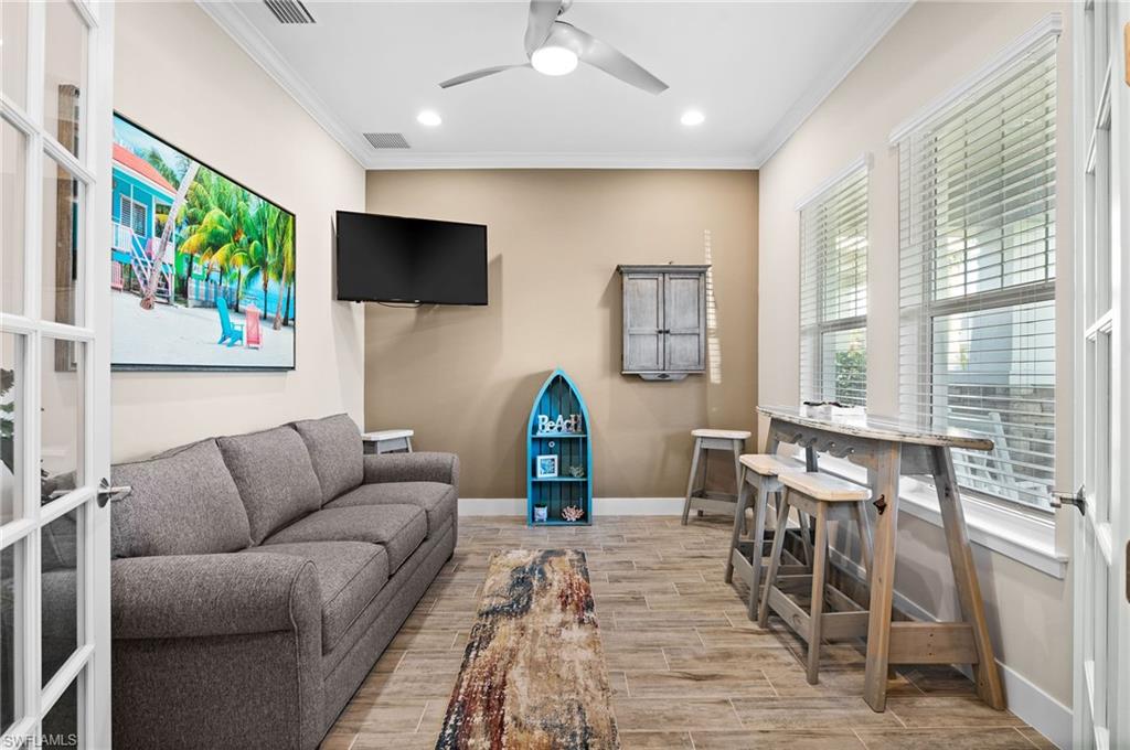 3521 Pilot Circle Naples, FL 34120 - Photo 13 of 36 a living room with furniture and a flat screen tv