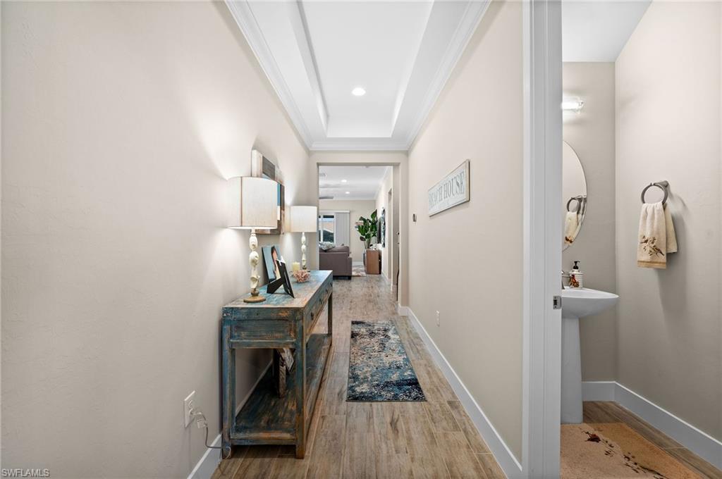 3521 Pilot Circle Naples, FL 34120 - Photo 15 of 36 a view of a hallway with wooden floor and staircase