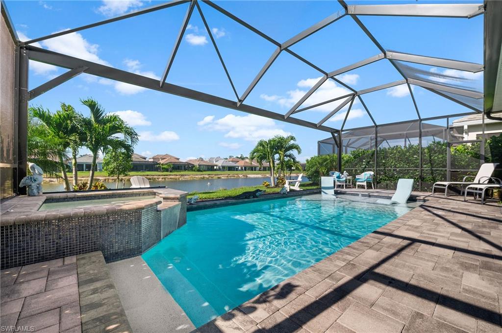 3521 Pilot Circle Naples, FL 34120 - Photo 21 of 36 a view of a patio with a table and chairs under an umbrella