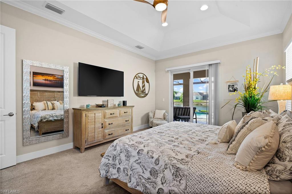 3521 Pilot Circle Naples, FL 34120 - Photo 24 of 36 a bedroom with a bed and a flat screen tv