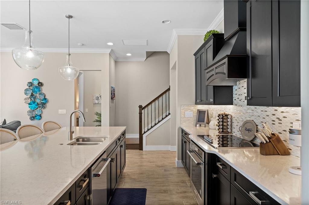 3521 Pilot Circle Naples, FL 34120 - Photo 3 of 36 a kitchen with stainless steel appliances a sink a stove and a wooden floors