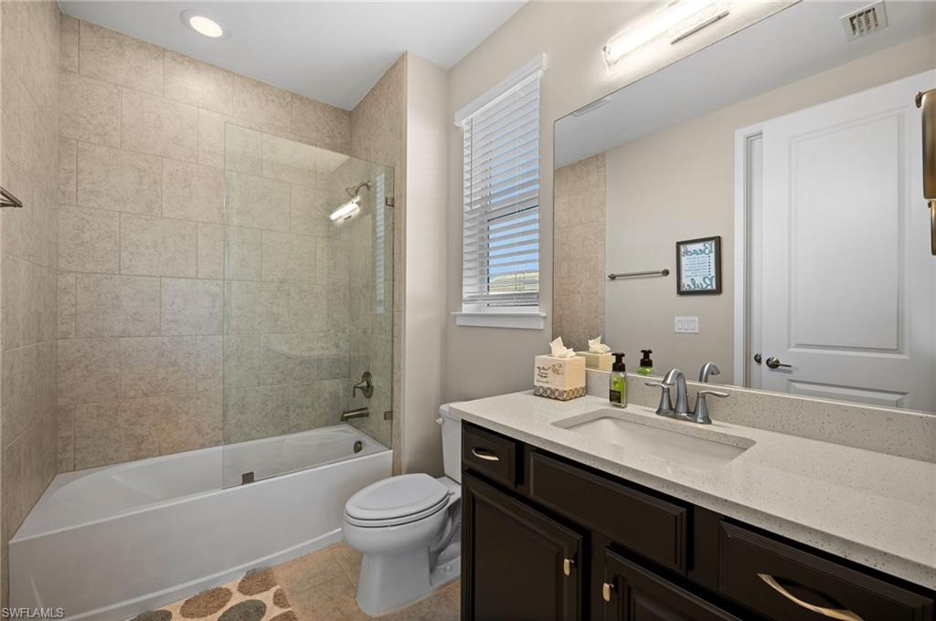 3521 Pilot Circle Naples, FL 34120 - Photo 32 of 36 a bathroom with a sink a toilet and shower