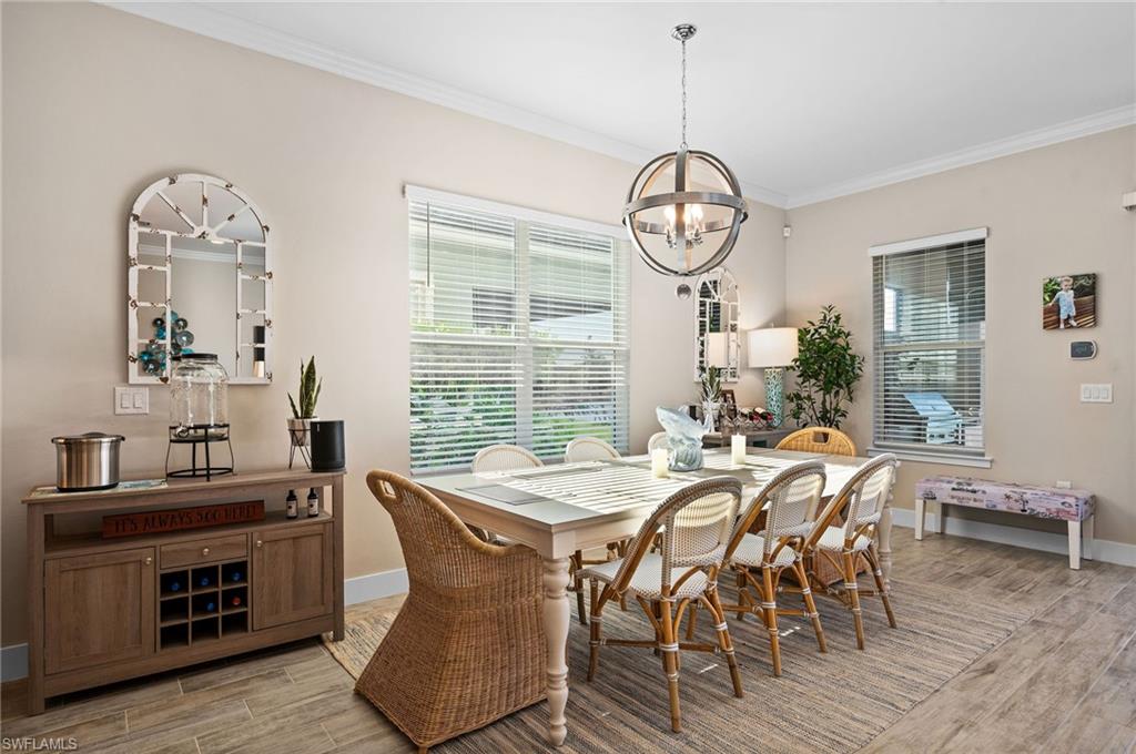 3521 Pilot Circle Naples, FL 34120 - Photo 7 of 36 a view of a dining room with furniture window and wooden floor