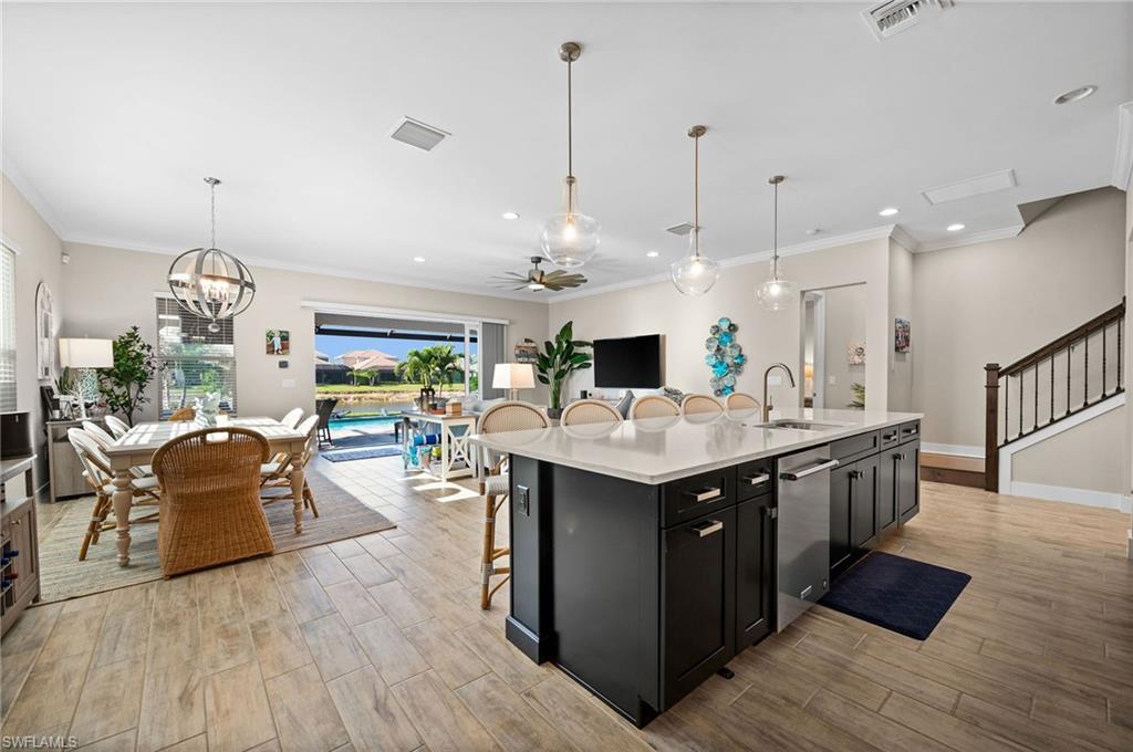 3521 Pilot Circle Naples, FL 34120 - Photo 8 of 36 a large kitchen with stainless steel appliances kitchen island granite countertop a large island in the center