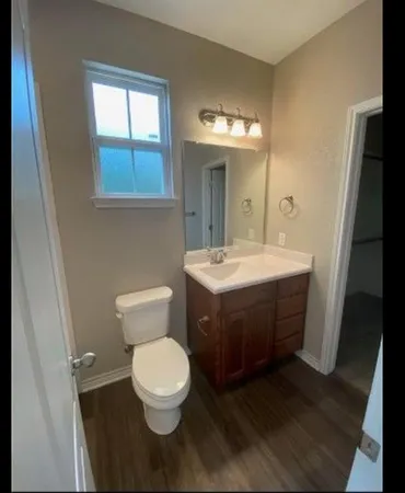 a bathroom with a toilet sink and mirror
