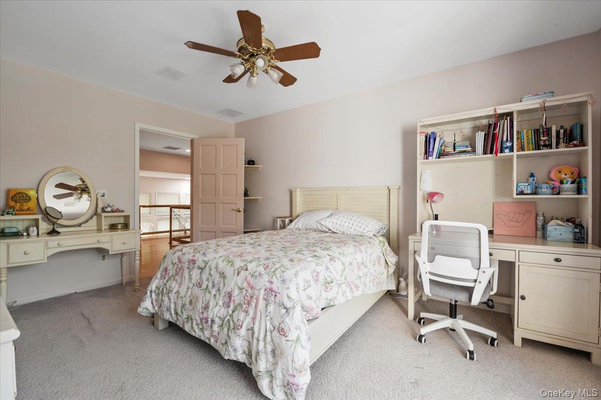 12 Ridge Court Glen Head, NY 11545 - Photo 37 of 46 Bedroom with light carpet, an office area, and a ceiling fan