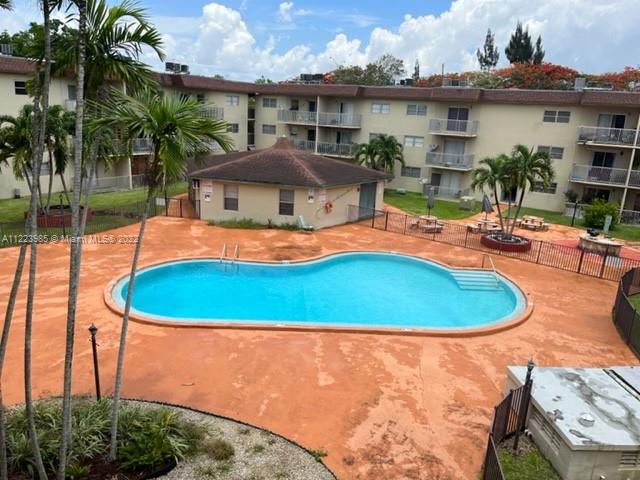 7505 Southwest 82nd Street, Unit 322 Miami, FL 33143 - Photo 1 of 10 an outdoor space with pool and furniture