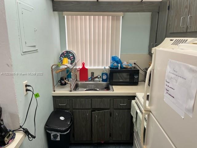 7505 Southwest 82nd Street, Unit 322 Miami, FL 33143 - Photo 3 of 10 a bathroom with a sink and a washing machine