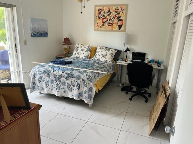 7505 Southwest 82nd Street, Unit 322 Miami, FL 33143 - Photo 6 of 10 a bedroom with a bed and furniture