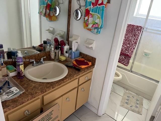 7505 Southwest 82nd Street, Unit 322 Miami, FL 33143 - Photo 7 of 10 a bathroom with a sink mirror and vanity