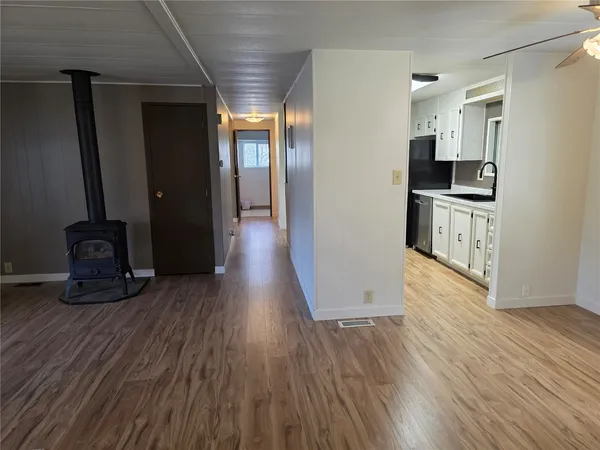 a kitchen with stainless steel appliances a refrigerator and wooden floor