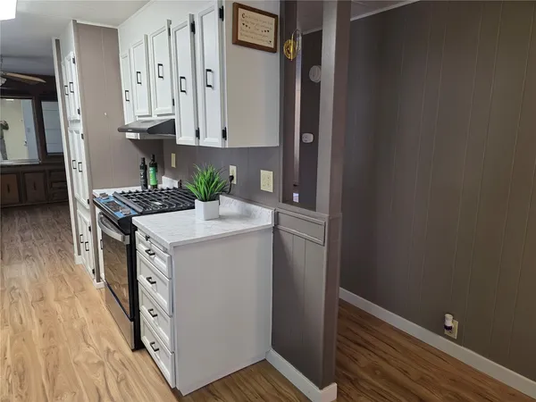 a view of kitchen with cabinets and wooden floor