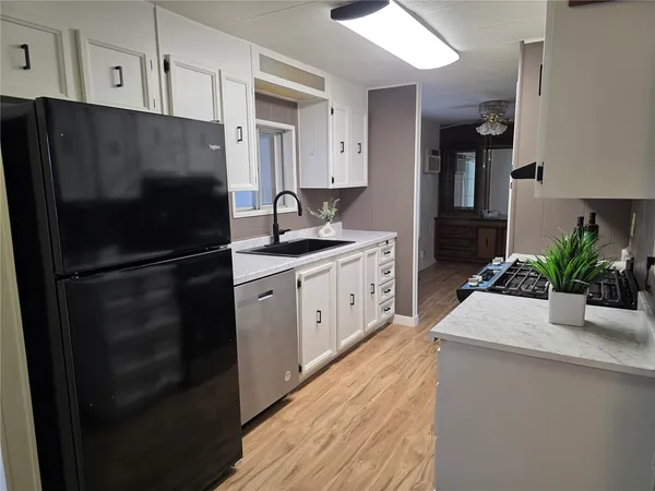 a kitchen with a refrigerator and a sink