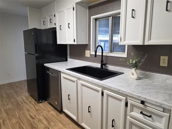 a kitchen with a sink and cabinets