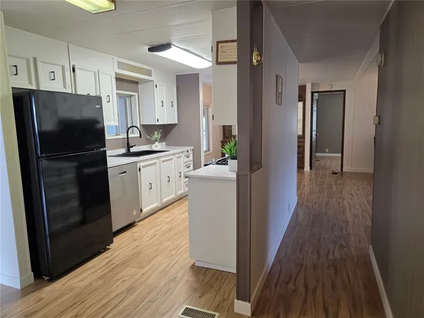 a kitchen with a refrigerator a sink and dishwasher