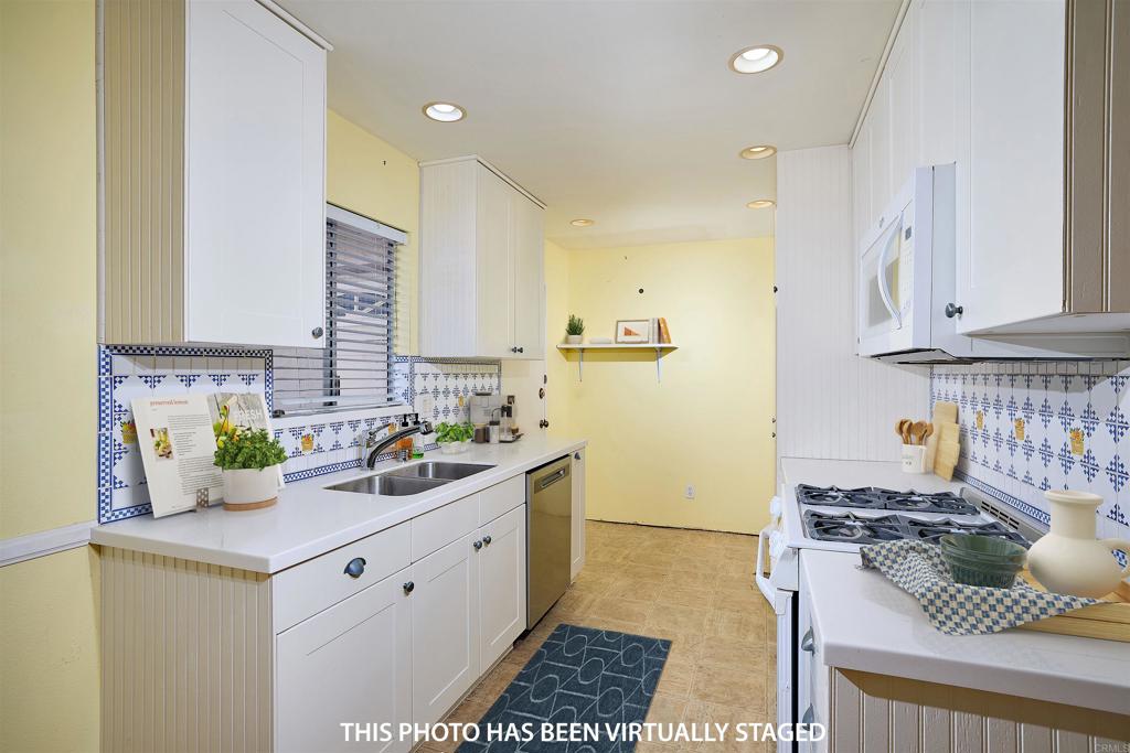400 San Dimas Avenue Oceanside, CA 92057 - Photo 8 of 28 a kitchen with a sink a stove and cabinets