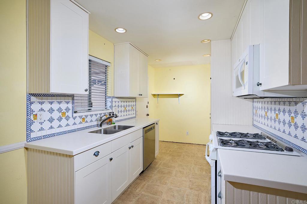 400 San Dimas Avenue Oceanside, CA 92057 - Photo 9 of 28 a kitchen with stainless steel appliances a stove and a refrigerator