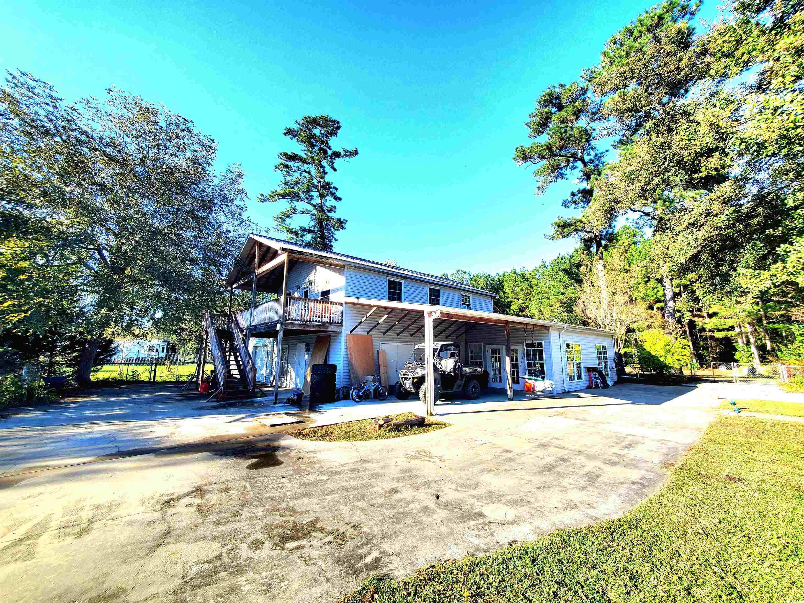 1484 Fitch Road Lake City, SC 29560 - Photo 37 of 40 View of front of house with driveway, stairs, a patio area, and a wooden deck