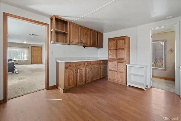 a view of an empty room with closet and entryway