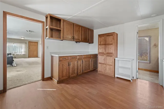 a view of an empty room with closet and entryway