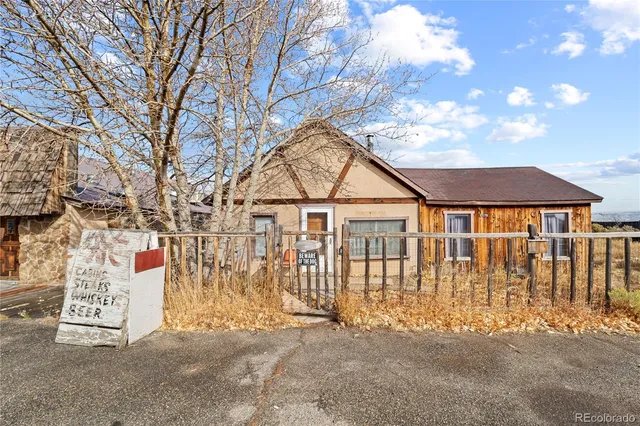 a view of wooden house with large windows