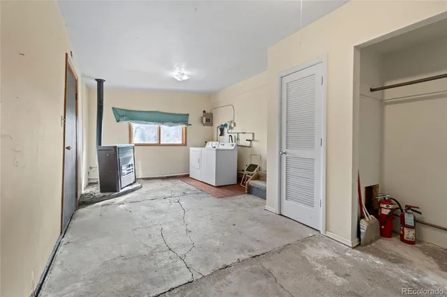 a room with pool table and chairs