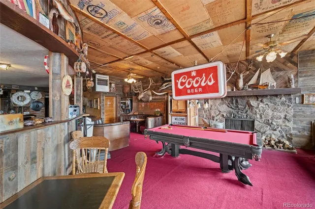 a kitchen with stainless steel appliances a sink dishwasher and white cabinets next to a window