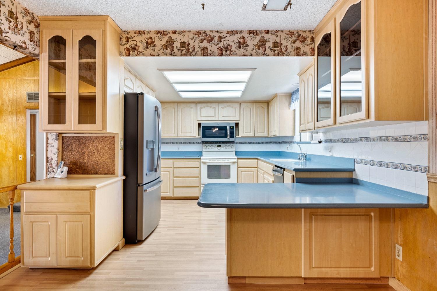 100 Hilton Street Madera, CA 93637 - Photo 18 of 30 a kitchen with stainless steel appliances granite countertop a sink and a cabinets