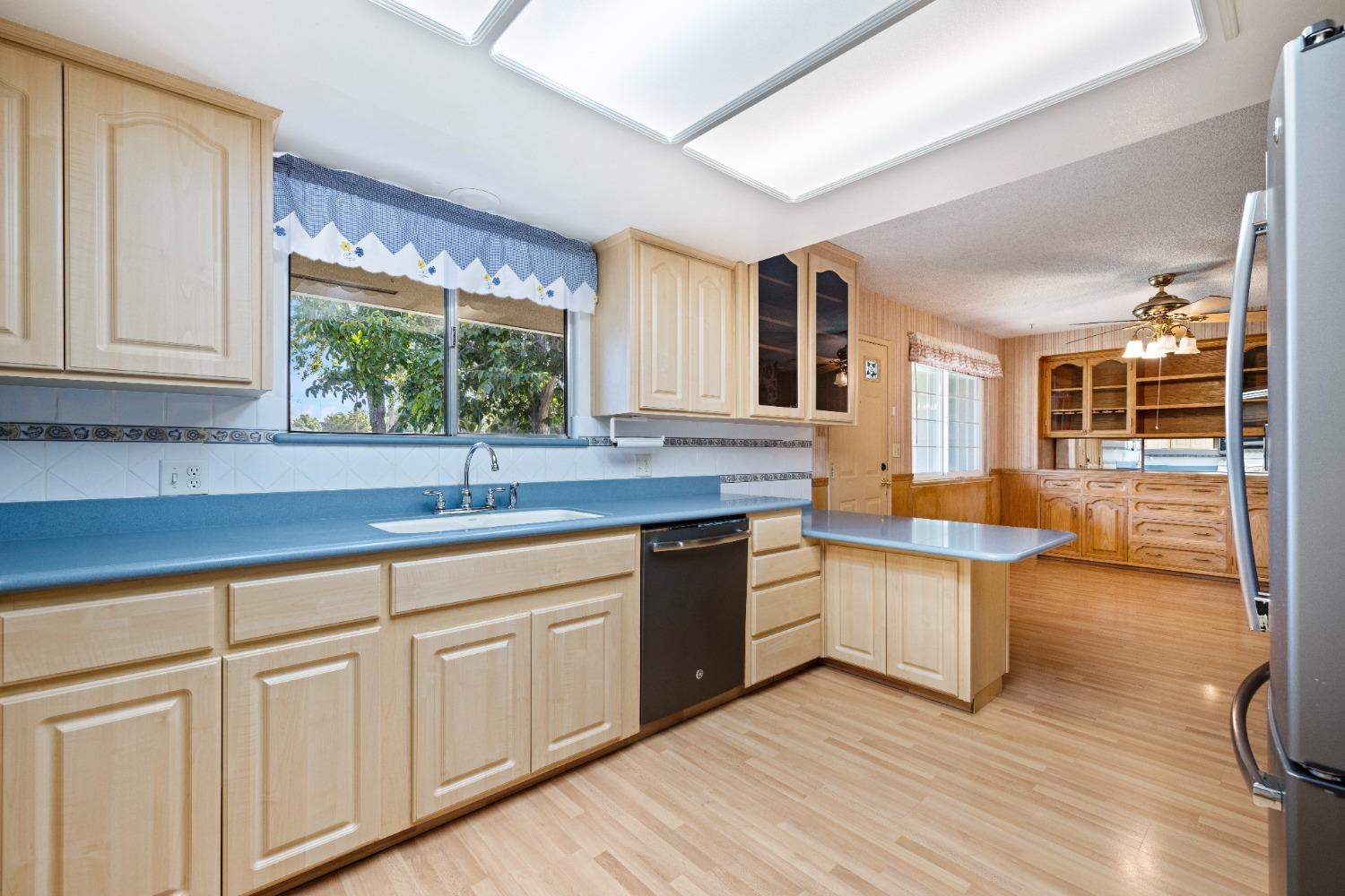 100 Hilton Street Madera, CA 93637 - Photo 21 of 30 a kitchen with stainless steel appliances granite countertop a white cabinets and sink