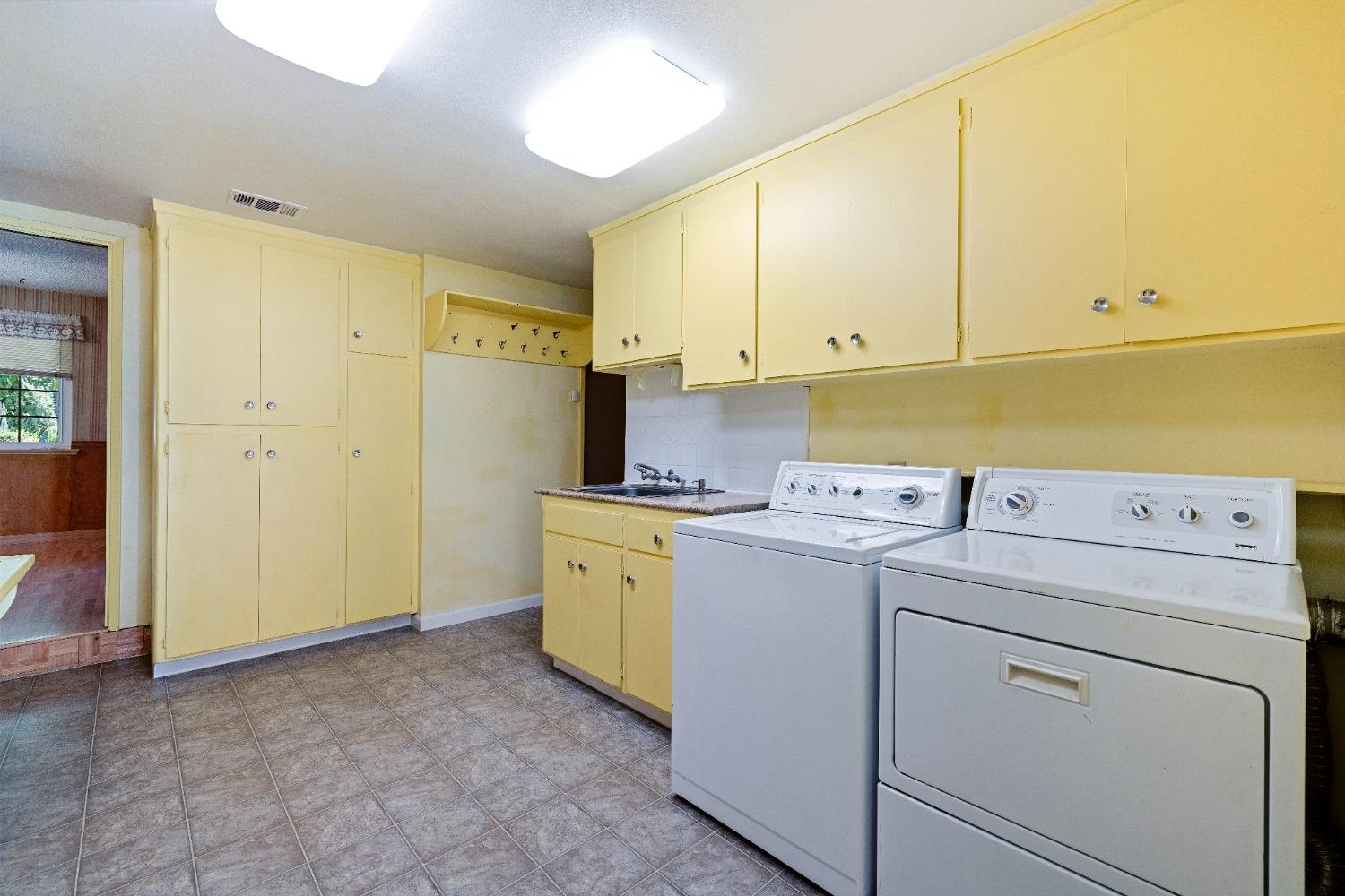100 Hilton Street Madera, CA 93637 - Photo 22 of 30 a view of storage and utility room with washer and dryer