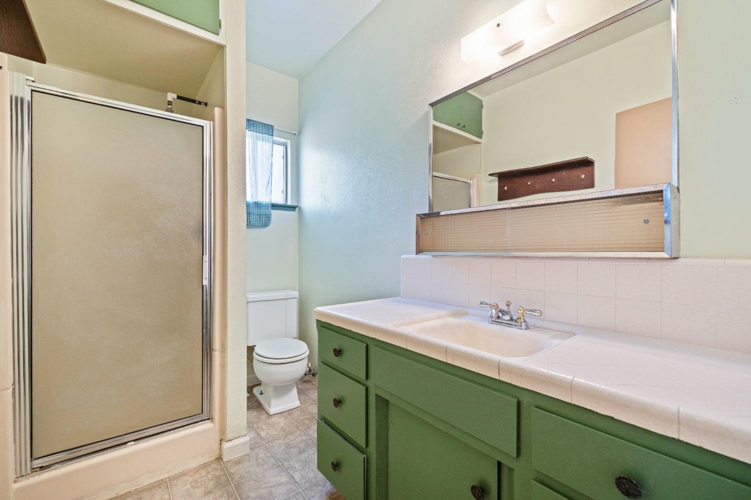 100 Hilton Street Madera, CA 93637 - Photo 25 of 30 a bathroom with a sink and a mirror