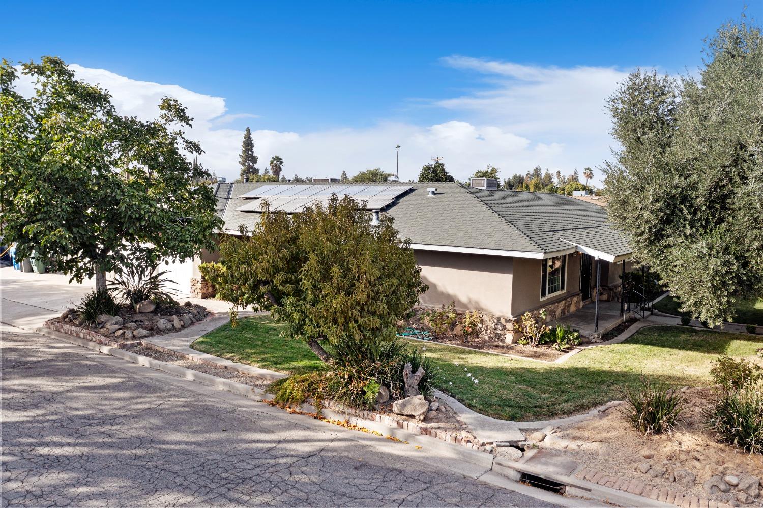 100 Hilton Street Madera, CA 93637 - Photo 3 of 30 a view of a house with a yard